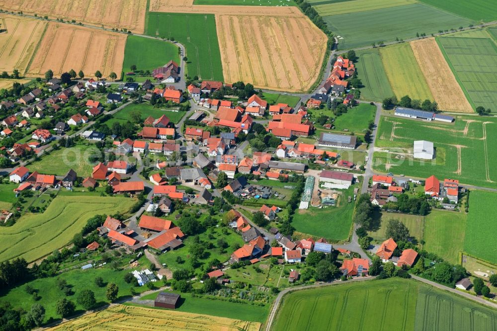 Dörrigsen from above - Agricultural land and field borders surround the settlement area of the village in Doerrigsen in the state Lower Saxony, Germany