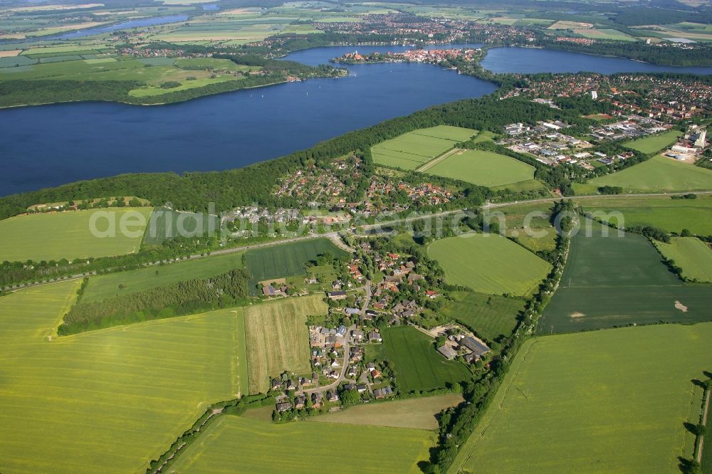 Aerial image Einhaus - Agricultural land and field borders surround the settlement area of the village in Einhaus in the state Schleswig-Holstein, Germany