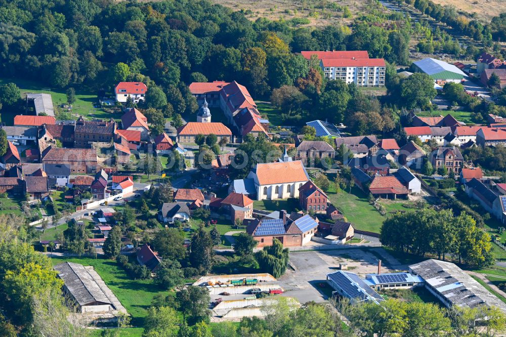 Aderstedt from above - Agricultural land and field boundaries surround the settlement area of the village in Aderstedt in the state Saxony-Anhalt, Germany