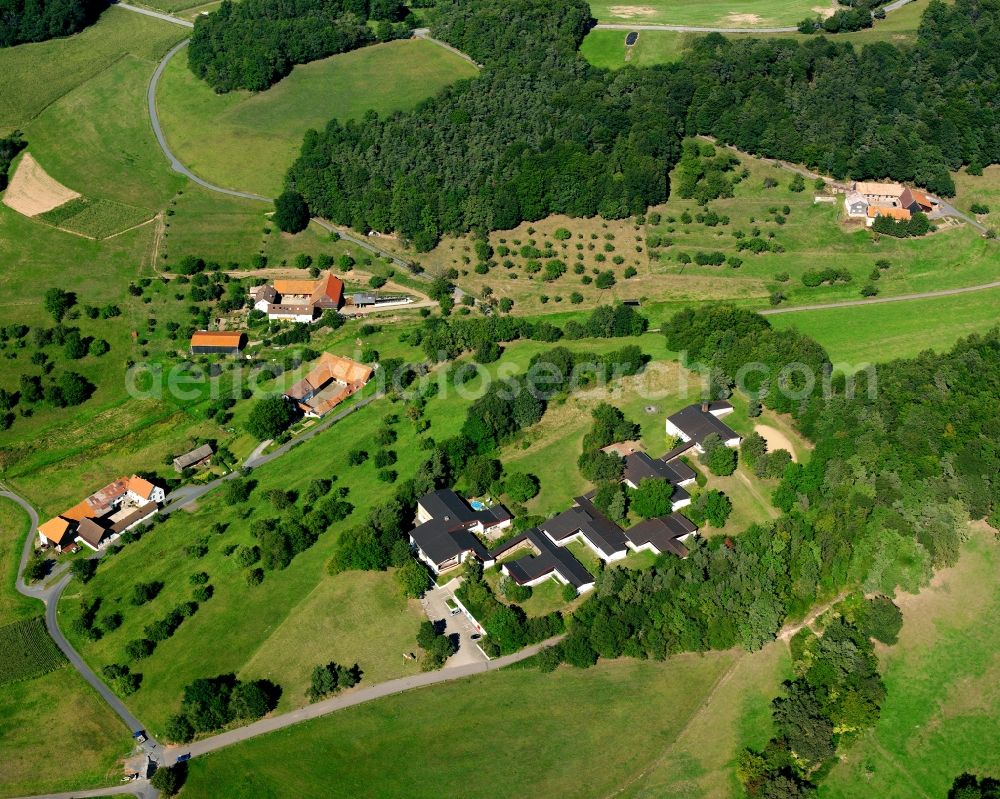 Affhöllerbach from above - Agricultural land and field boundaries surround the settlement area of the village in Affhöllerbach in the state Hesse, Germany