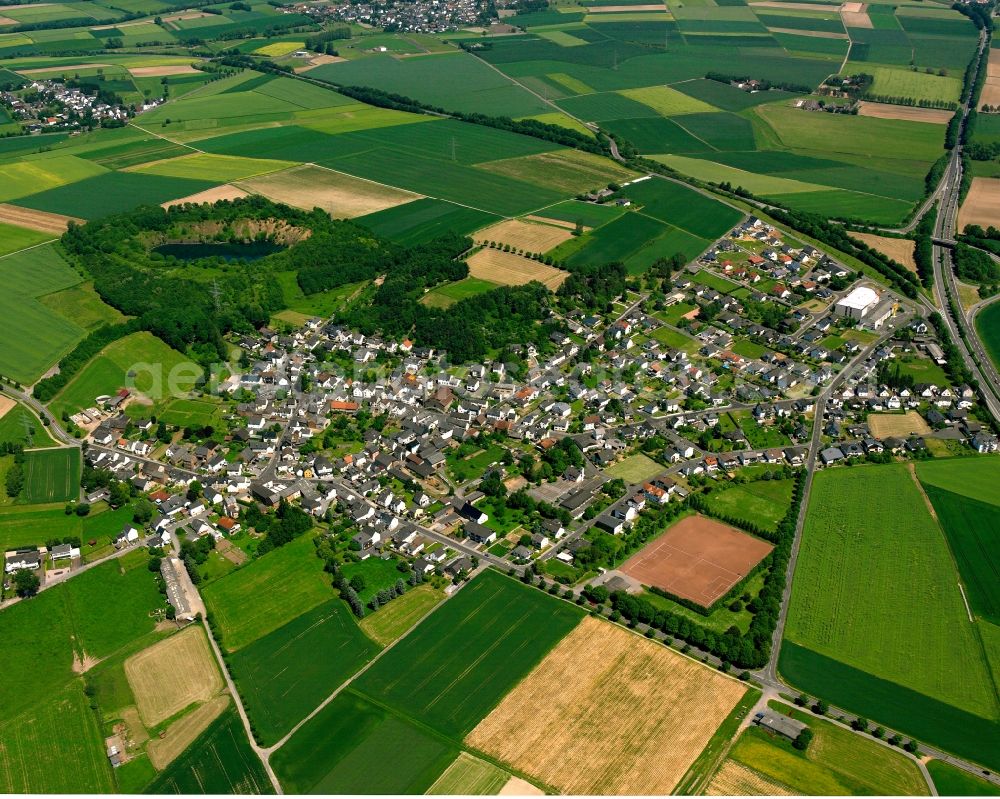 Aerial image Ahlbach - Agricultural land and field boundaries surround the settlement area of the village in Ahlbach in the state Hesse, Germany