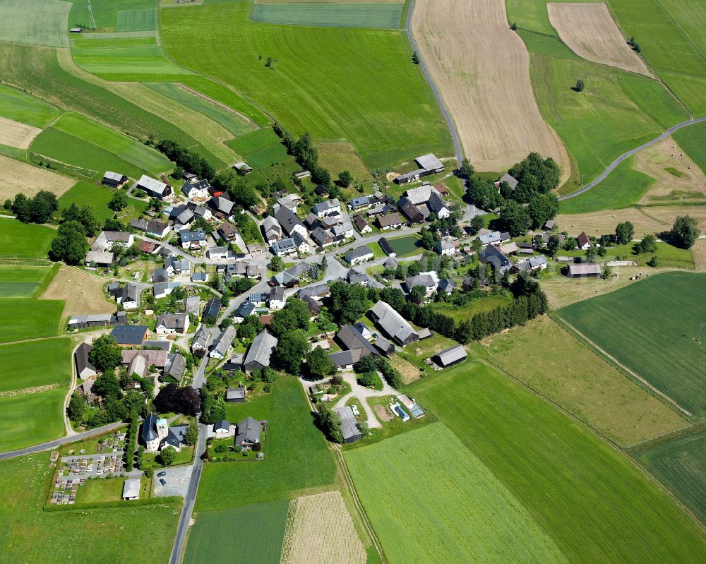 Aerial image Ahornis - Agricultural land and field boundaries surround the settlement area of the village in Ahornis in the state Bavaria, Germany
