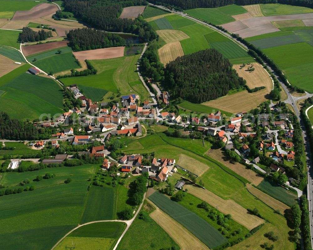 Aich from above - Agricultural land and field boundaries surround the settlement area of the village in Aich in the state Bavaria, Germany