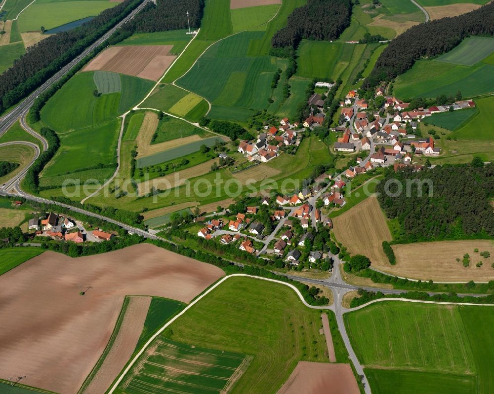 Aich from the bird's eye view: Agricultural land and field boundaries surround the settlement area of the village in Aich in the state Bavaria, Germany