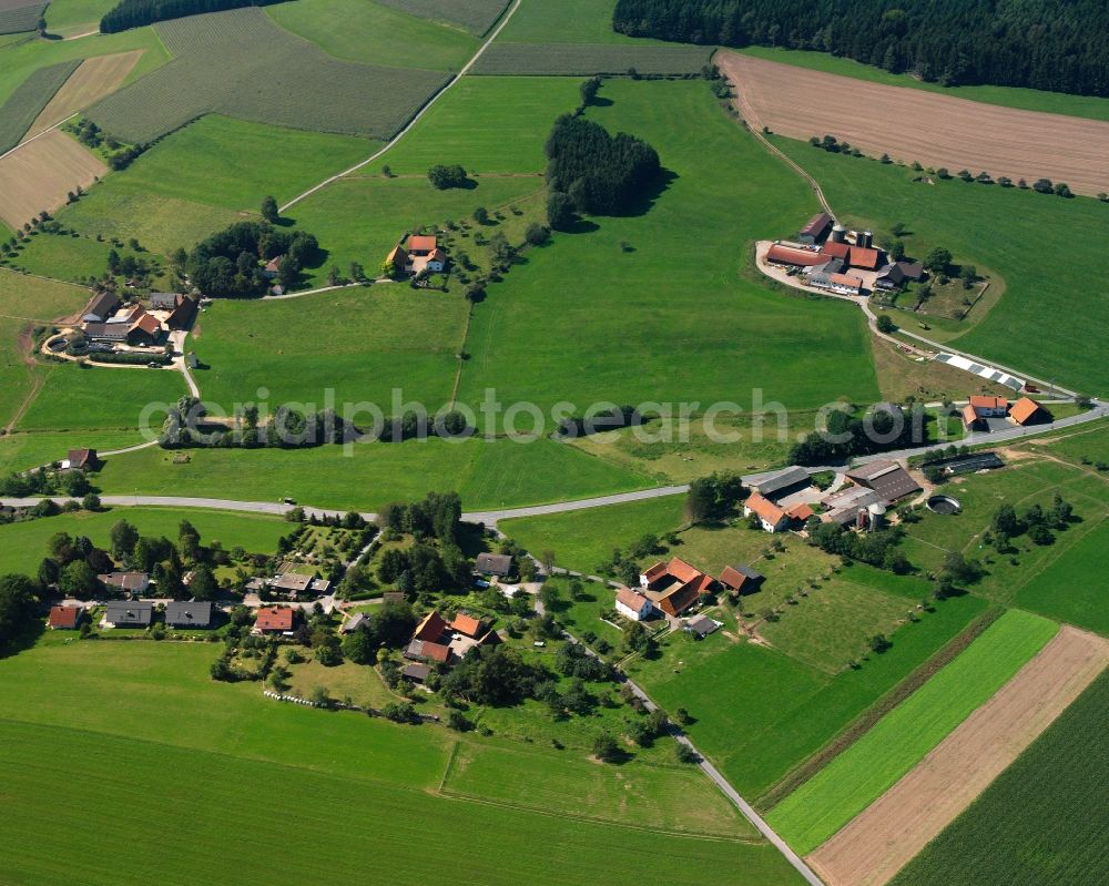 Airlenbach from above - Agricultural land and field boundaries surround the settlement area of the village in Airlenbach in the state Hesse, Germany