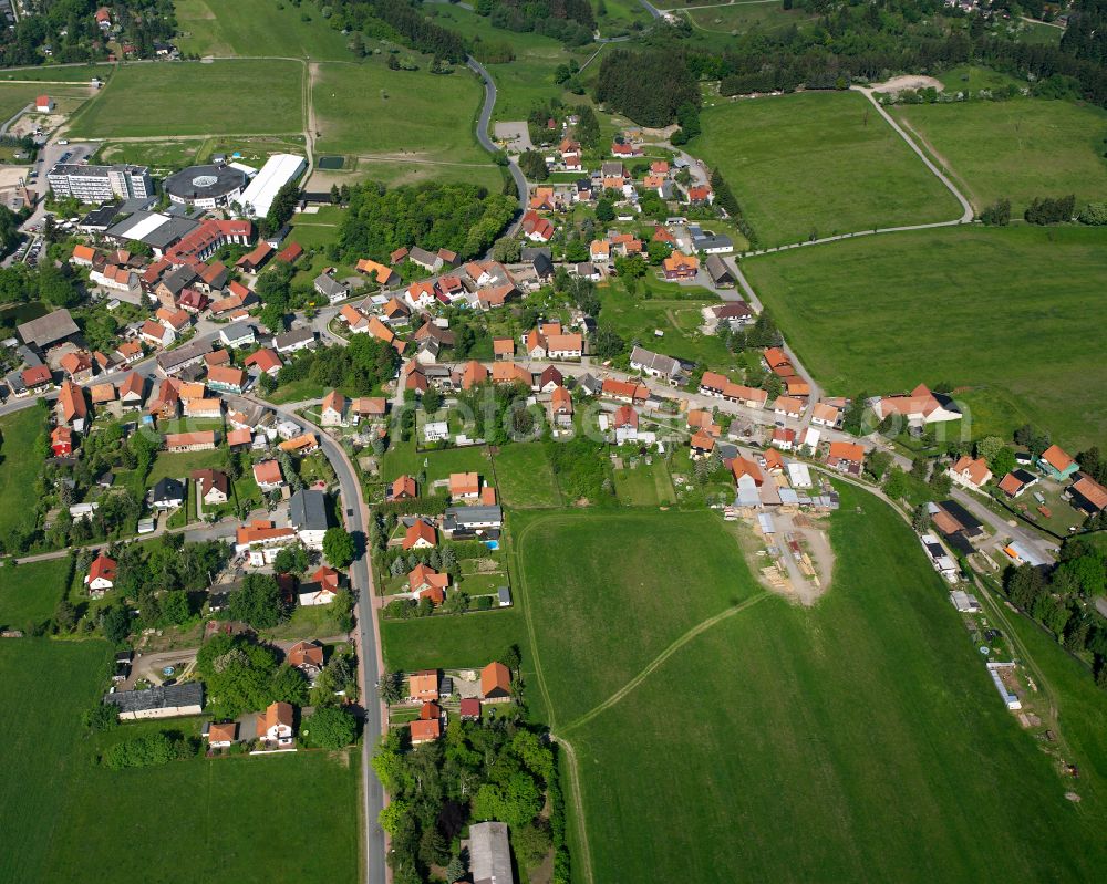 Allrode from above - Agricultural land and field boundaries surround the settlement area of the village in Allrode in the state Saxony-Anhalt, Germany