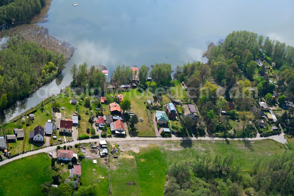 Altfriesack from above - Agricultural land and field boundaries surround the settlement area of the village in Altfriesack in the state Brandenburg, Germany