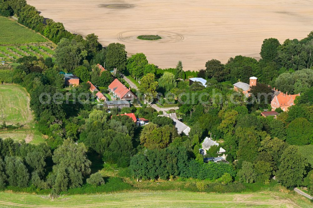 Aerial image Amalienhof - Agricultural land and field boundaries surround the settlement area of the village in Amalienhof in the Uckermark in the state Brandenburg, Germany