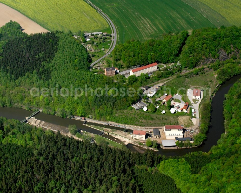 Amerika from above - Agricultural land and field boundaries surround the settlement area of the village in Amerika in the state Saxony, Germany