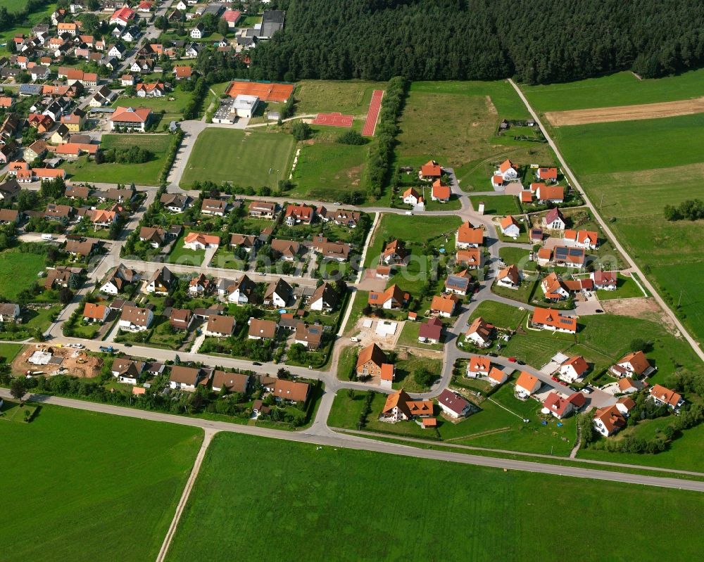 Ammelbruch from the bird's eye view: Agricultural land and field boundaries surround the settlement area of the village in Ammelbruch in the state Bavaria, Germany