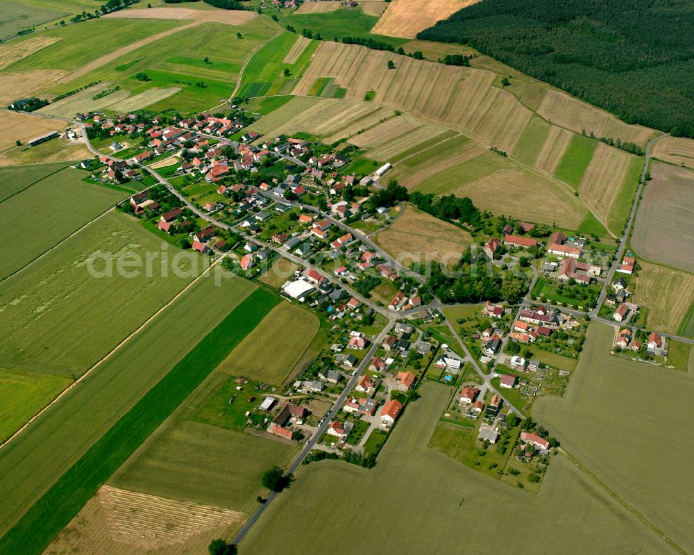 Aerial image Anbau - Agricultural land and field boundaries surround the settlement area of the village in Anbau in the state Saxony, Germany