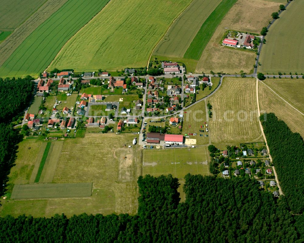 Anbau from above - Agricultural land and field boundaries surround the settlement area of the village in Anbau in the state Saxony, Germany