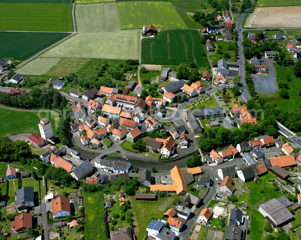 Aerial photograph Angenrod - Agricultural land and field boundaries surround the settlement area of the village in Angenrod in the state Hesse, Germany