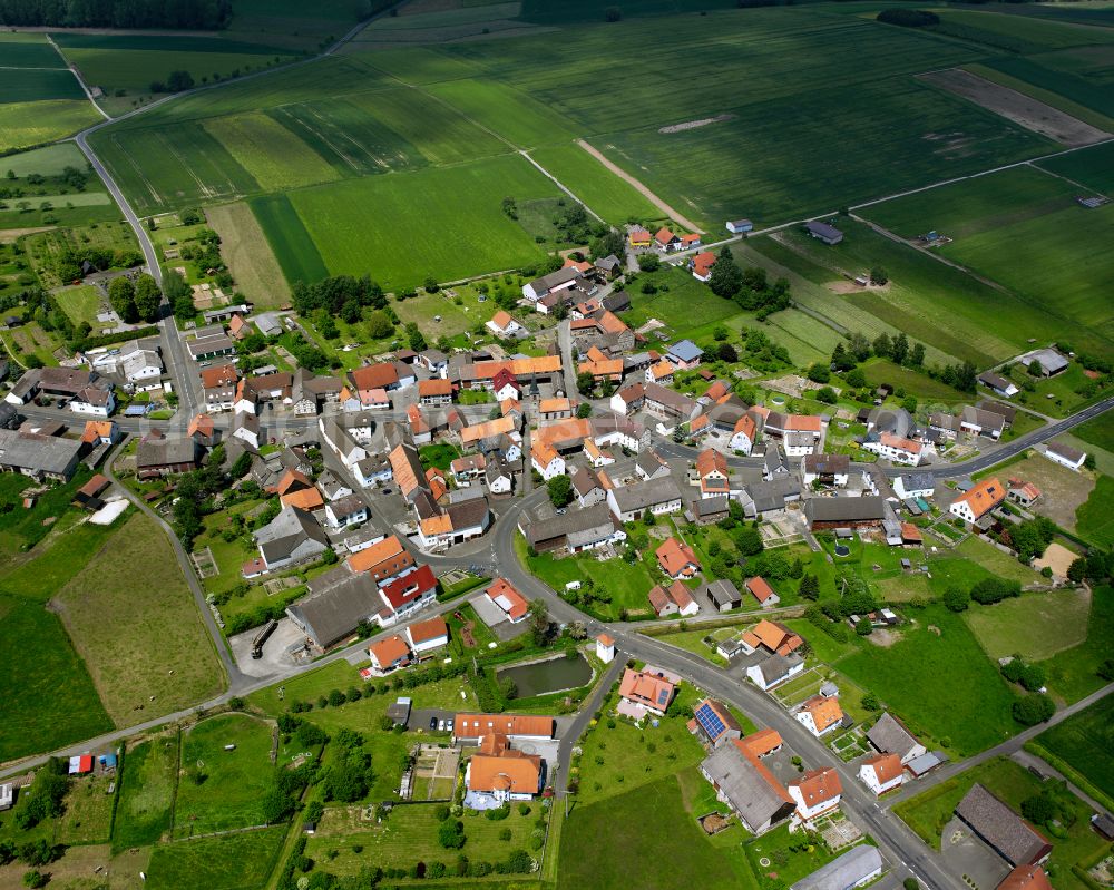 Appenrod from above - Agricultural land and field boundaries surround the settlement area of the village in Appenrod in the state Hesse, Germany