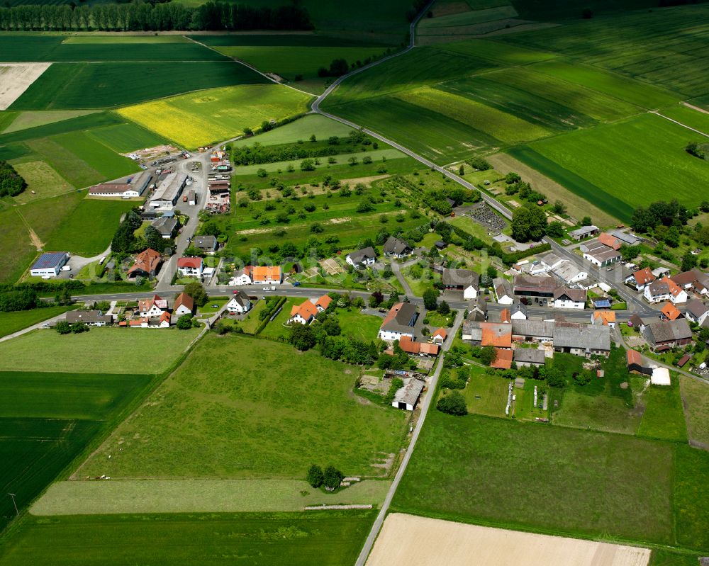 Appenrod from the bird's eye view: Agricultural land and field boundaries surround the settlement area of the village in Appenrod in the state Hesse, Germany