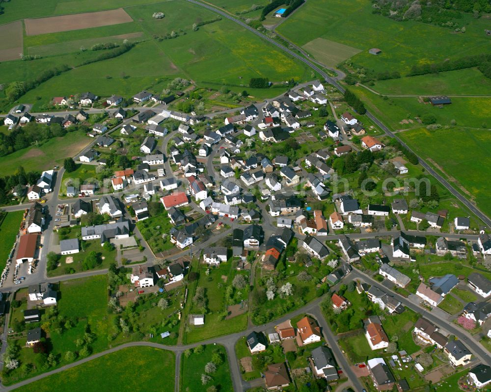 Arborn from above - Agricultural land and field boundaries surround the settlement area of the village in Arborn in the state Hesse, Germany