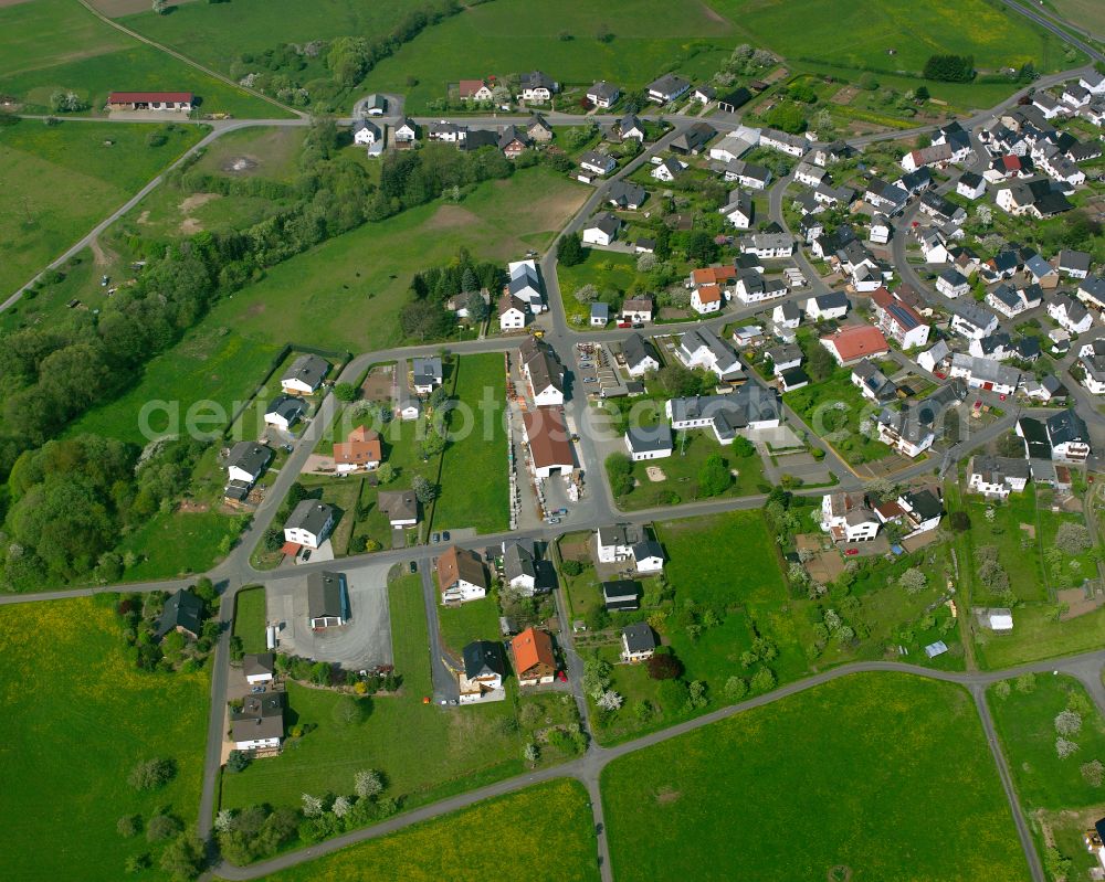 Arborn from the bird's eye view: Agricultural land and field boundaries surround the settlement area of the village in Arborn in the state Hesse, Germany