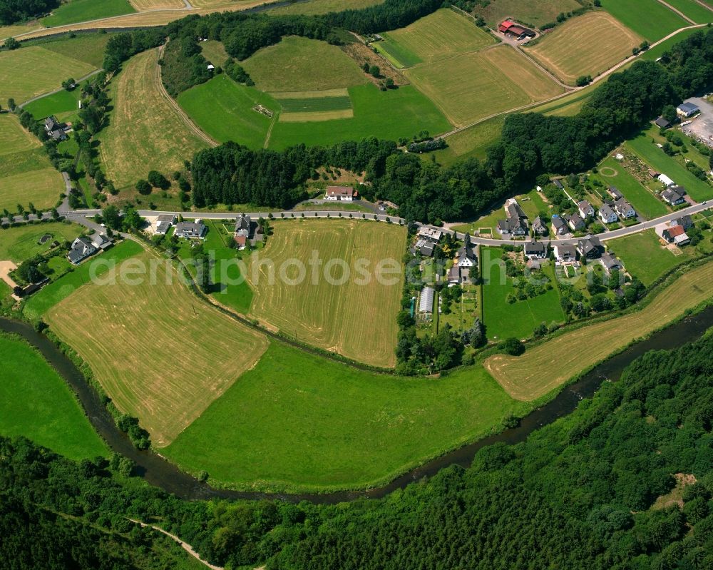 Arfeld from above - Agricultural land and field boundaries surround the settlement area of the village in Arfeld in the state North Rhine-Westphalia, Germany