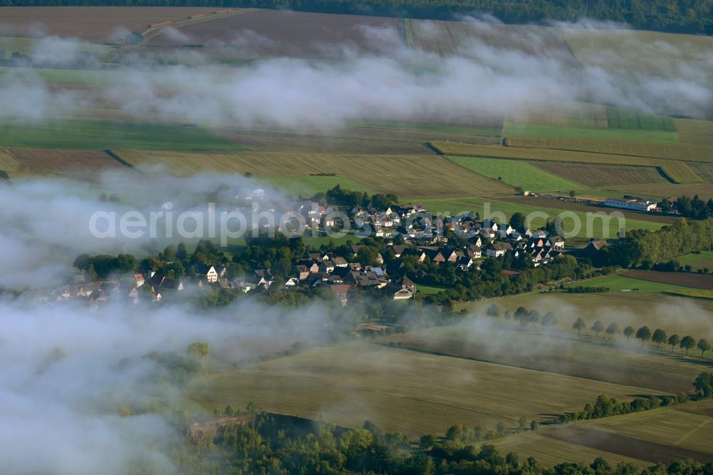 Arholzen from the bird's eye view: Agricultural land and field boundaries surround the settlement area of the village on street Hauptstrasse in Arholzen in the state Lower Saxony, Germany