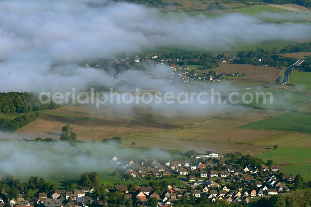 Arholzen from above - Agricultural land and field boundaries surround the settlement area of the village on street Hauptstrasse in Arholzen in the state Lower Saxony, Germany