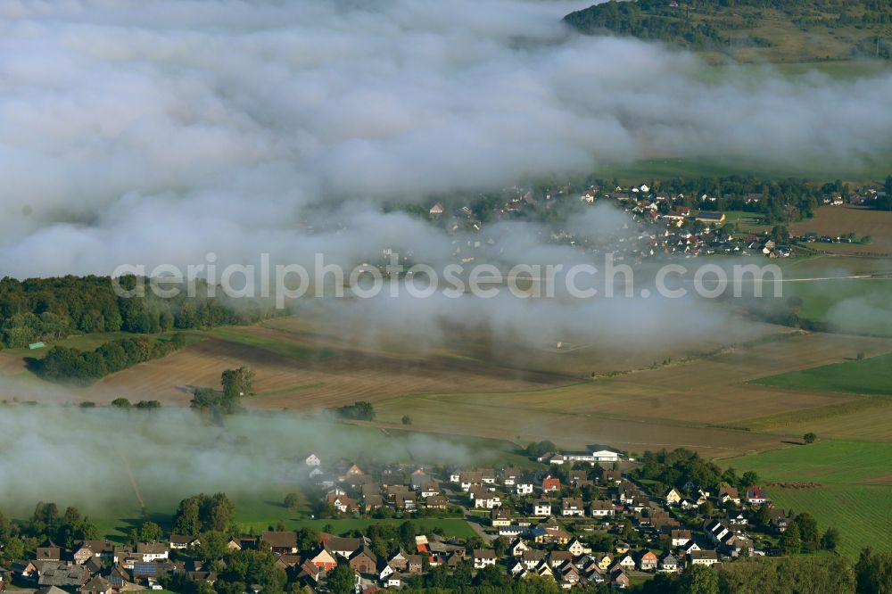 Arholzen from the bird's eye view: Agricultural land and field boundaries surround the settlement area of the village on street Hauptstrasse in Arholzen in the state Lower Saxony, Germany