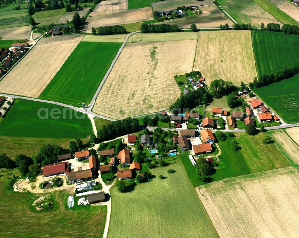 Armeding from above - Agricultural land and field boundaries surround the settlement area of the village in Armeding in the state Bavaria, Germany