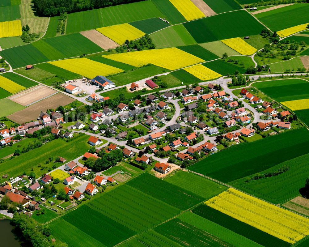 Attenweiler from above - Agricultural land and field boundaries surround the settlement area of the village in Attenweiler in the state Baden-Wuerttemberg, Germany