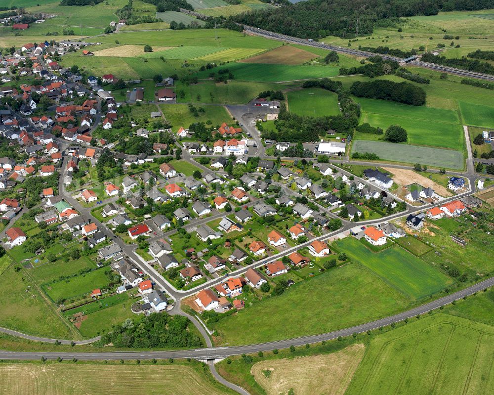 Atzenhain from the bird's eye view: Agricultural land and field boundaries surround the settlement area of the village in Atzenhain in the state Hesse, Germany