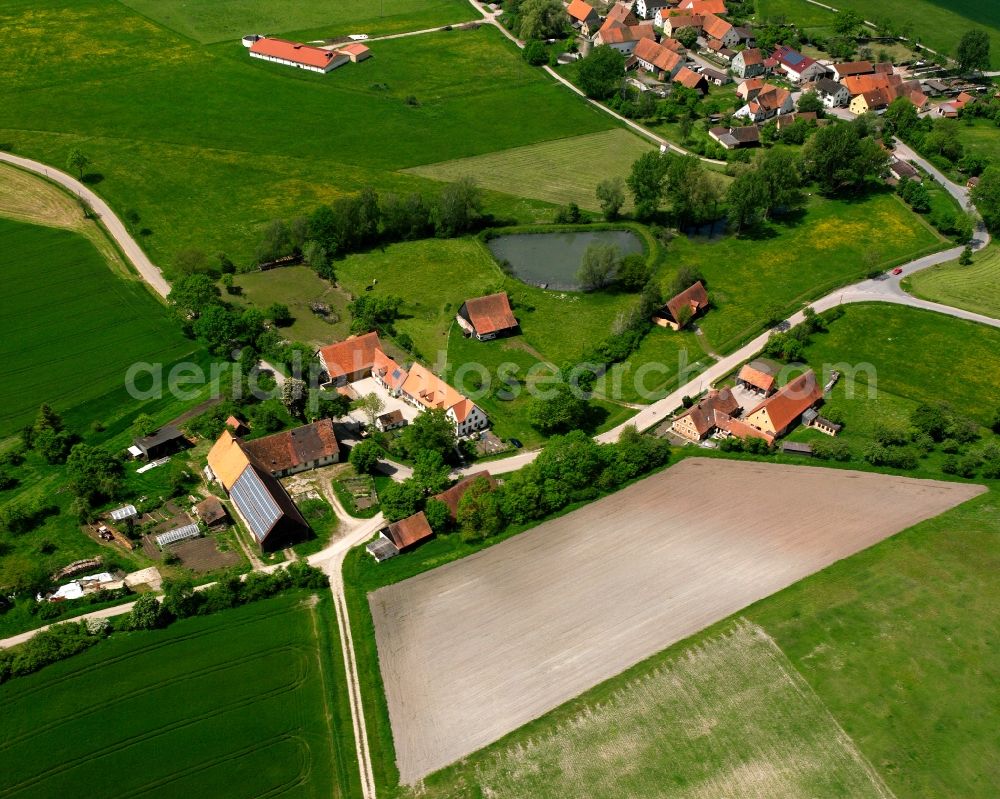 Atzenhofen from the bird's eye view: Agricultural land and field boundaries surround the settlement area of the village in Atzenhofen in the state Bavaria, Germany