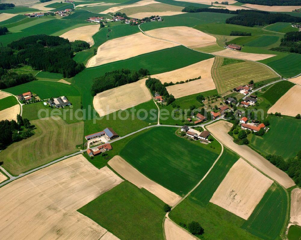 Atzing from above - Agricultural land and field boundaries surround the settlement area of the village in Atzing in the state Bavaria, Germany