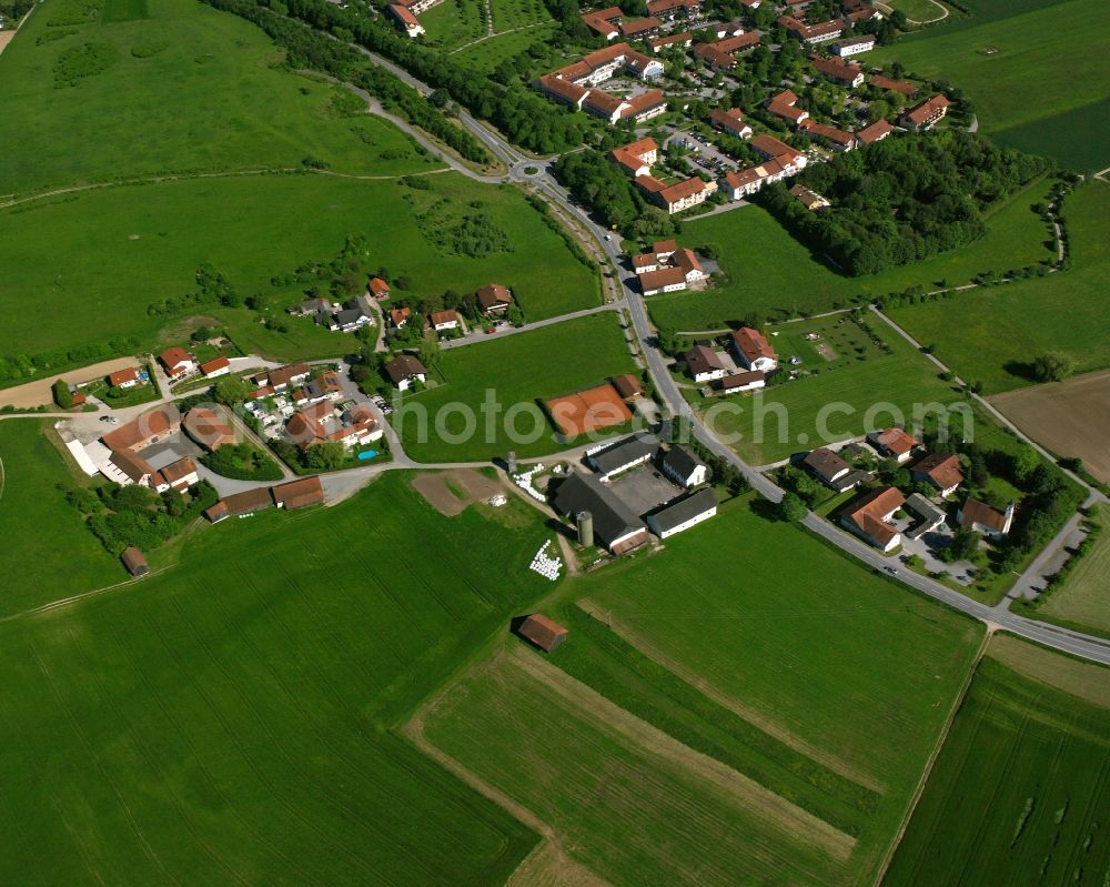 Aunham from above - Agricultural land and field boundaries surround the settlement area of the village in Aunham in the state Bavaria, Germany