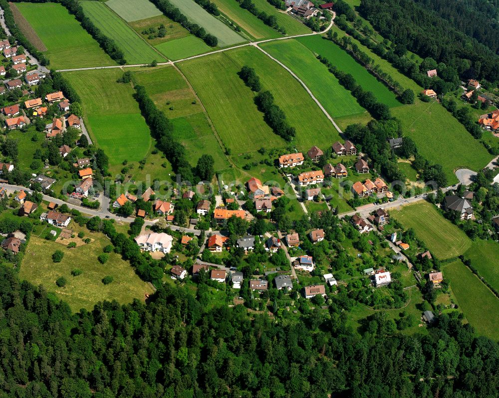 Bad Liebenzell from the bird's eye view: Agricultural land and field boundaries surround the settlement area of the village in Bad Liebenzell in the state Baden-Wuerttemberg, Germany