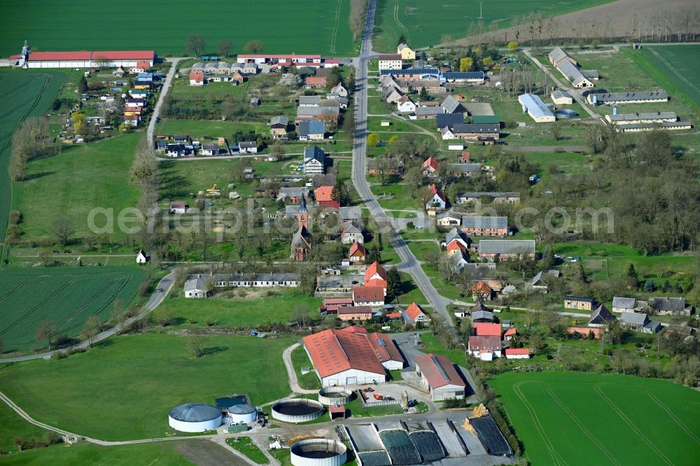 Bagemuehl from above - Agricultural land and field boundaries surround the settlement area of the village in Bagemuehl in the state Brandenburg, Germany