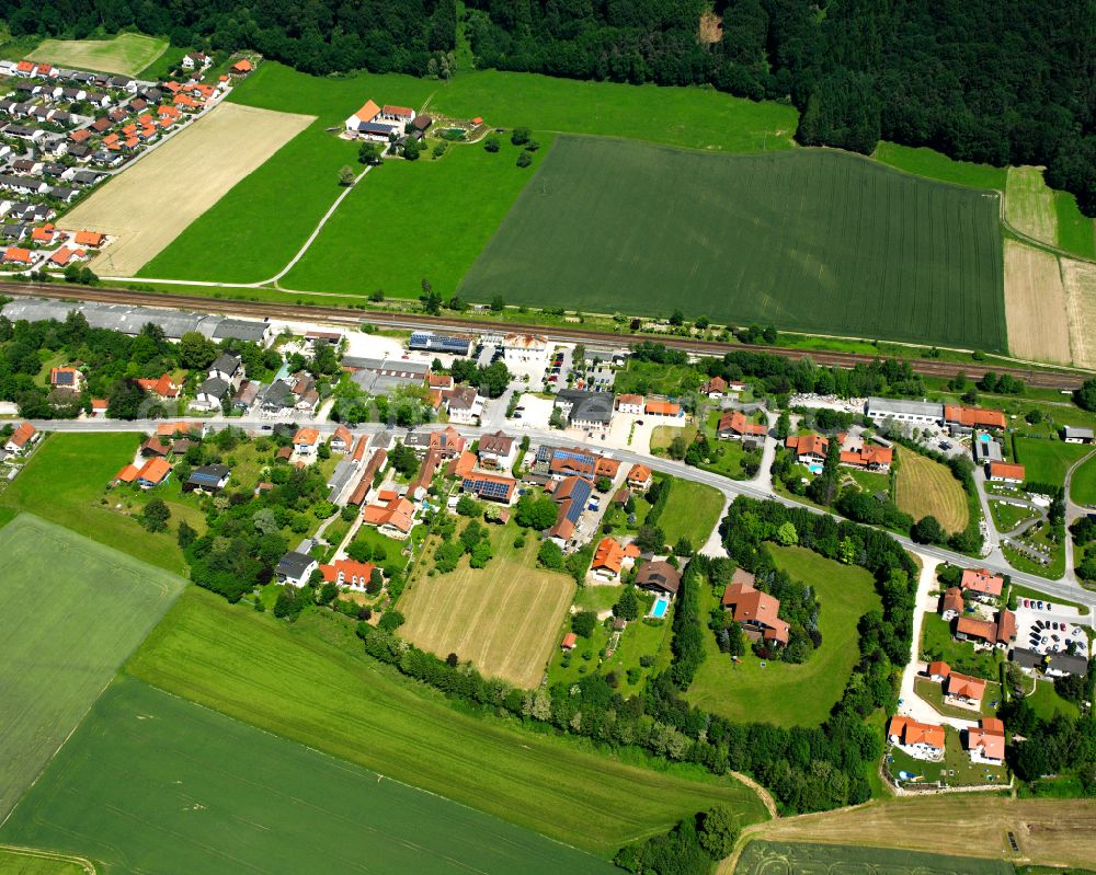 Am Bahnhof from above - Agricultural land and field boundaries surround the settlement area of the village in Am Bahnhof in the state Bavaria, Germany