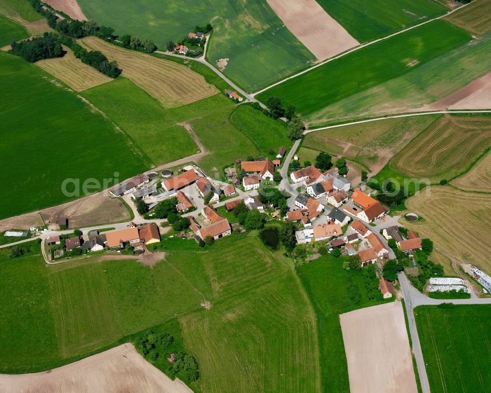 Ballstadt from above - Agricultural land and field boundaries surround the settlement area of the village in Ballstadt in the state Bavaria, Germany