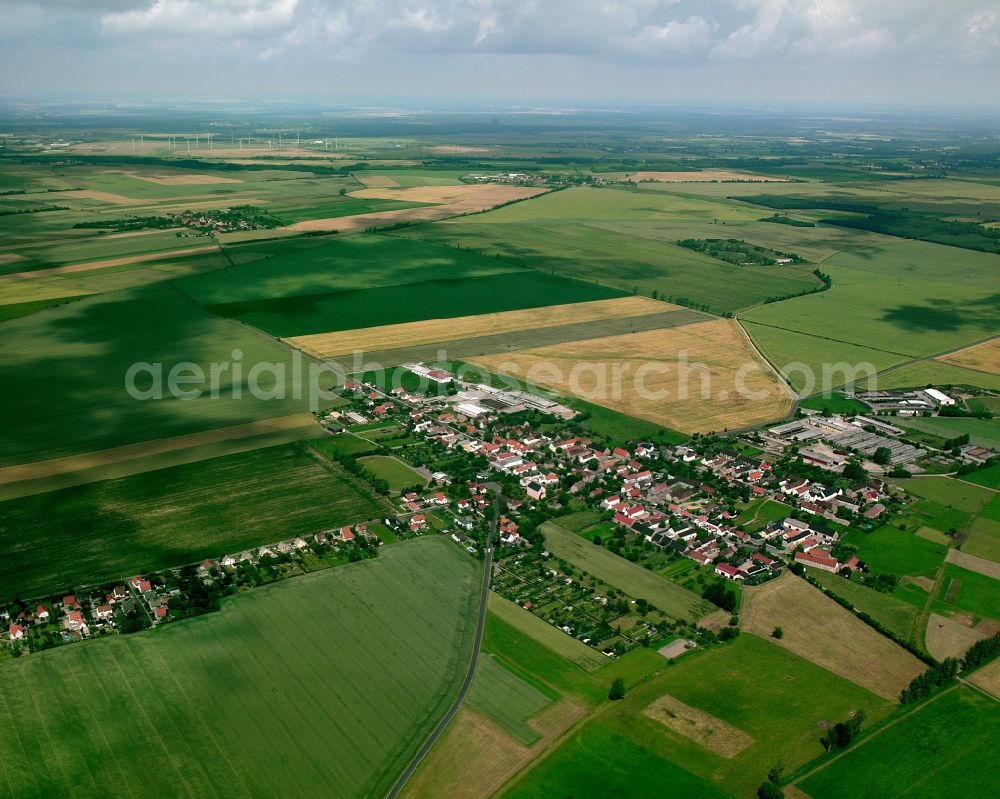 Aerial photograph Bauda - Agricultural land and field boundaries surround the settlement area of the village in Bauda in the state Saxony, Germany