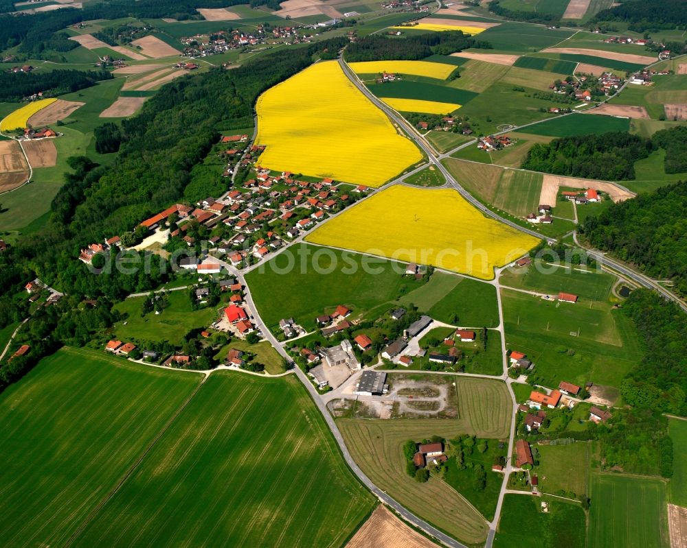 Baumgarten from above - Agricultural land and field boundaries surround the settlement area of the village in Baumgarten in the state Bavaria, Germany