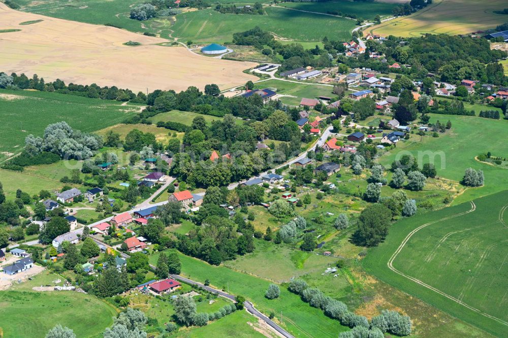 Baumgarten from above - Agricultural land and field boundaries surround the settlement area of the village in Baumgarten in the state Mecklenburg - Western Pomerania, Germany