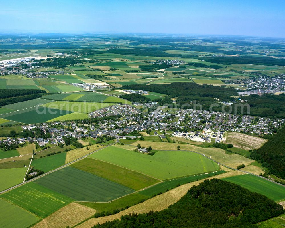 Aerial image Büchenbeuren - Agricultural land and field boundaries surround the settlement area of the village in Büchenbeuren in the state Rhineland-Palatinate, Germany