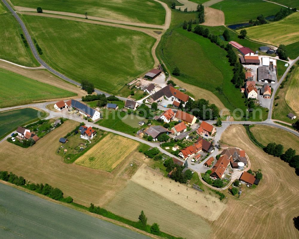 Böckau from above - Agricultural land and field boundaries surround the settlement area of the village in Böckau in the state Bavaria, Germany