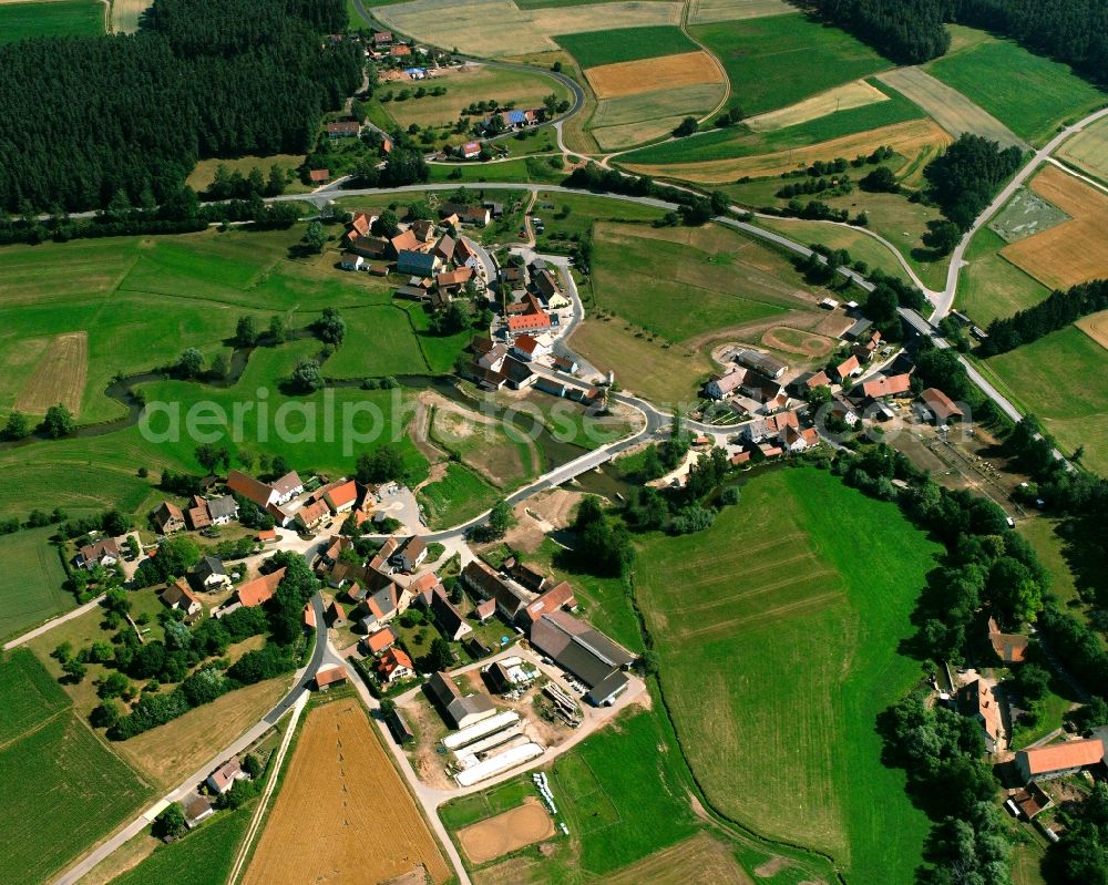 Bechhofen from above - Agricultural land and field boundaries surround the settlement area of the village in Bechhofen in the state Bavaria, Germany