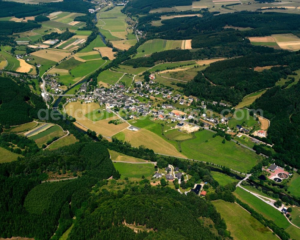 Beddelhausen from above - Agricultural land and field boundaries surround the settlement area of the village in Beddelhausen in the state North Rhine-Westphalia, Germany