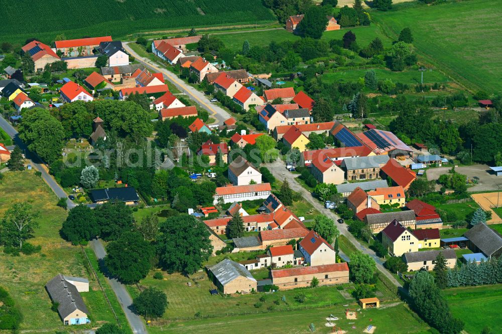 Aerial image Beelitz - Agricultural land and field boundaries surround the settlement area of the village in Beelitz in the state Brandenburg, Germany