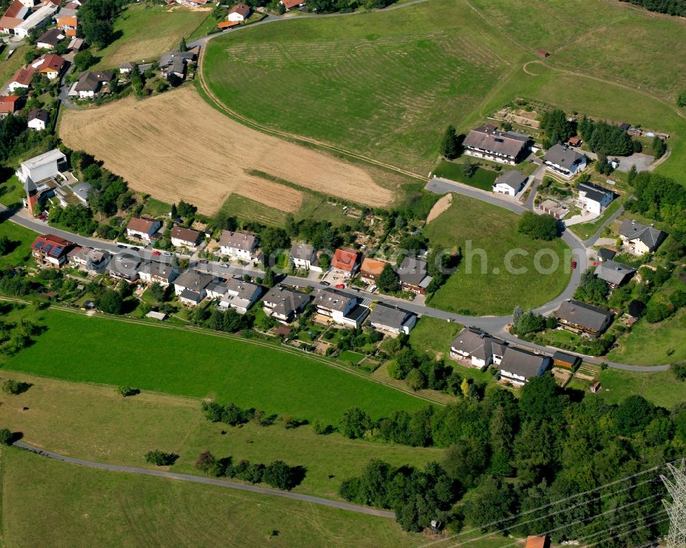 Beerfurth from above - Agricultural land and field boundaries surround the settlement area of the village in Beerfurth in the state Hesse, Germany