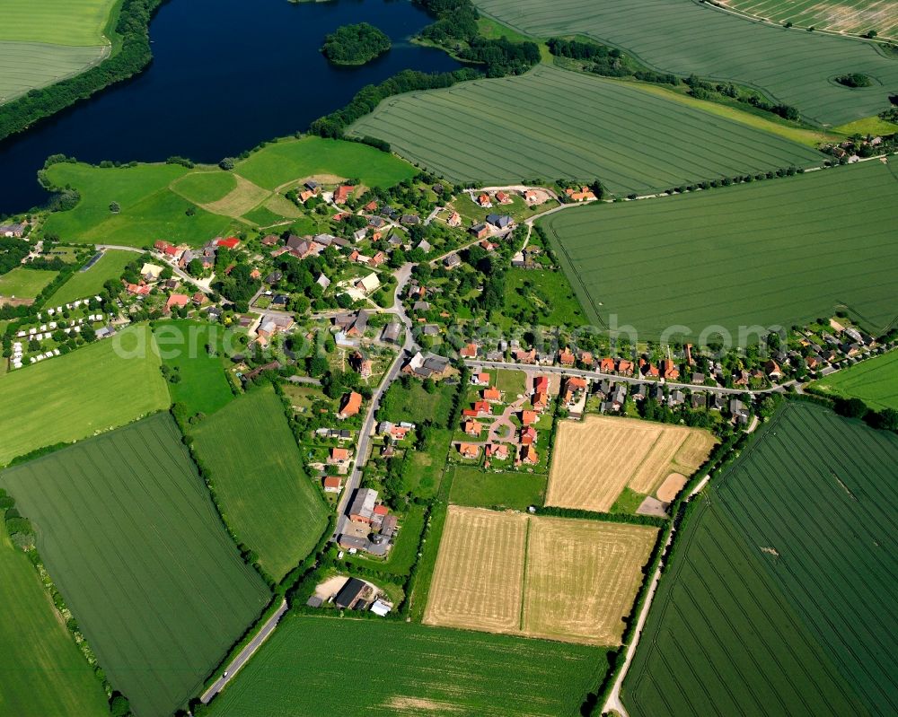 Behlendorf from above - Agricultural land and field boundaries surround the settlement area of the village in Behlendorf in the state Schleswig-Holstein, Germany