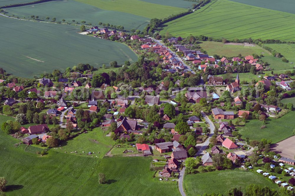 Aerial image Behlendorf - Agricultural land and field boundaries surround the settlement area of the village in Behlendorf in the state Schleswig-Holstein, Germany