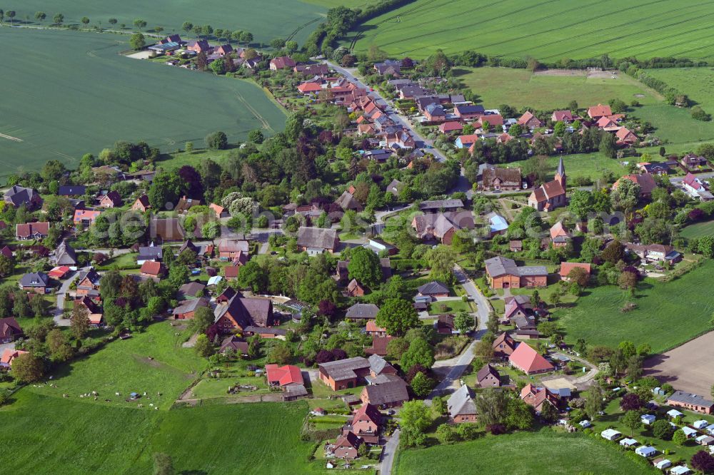 Aerial photograph Behlendorf - Agricultural land and field boundaries surround the settlement area of the village in Behlendorf in the state Schleswig-Holstein, Germany