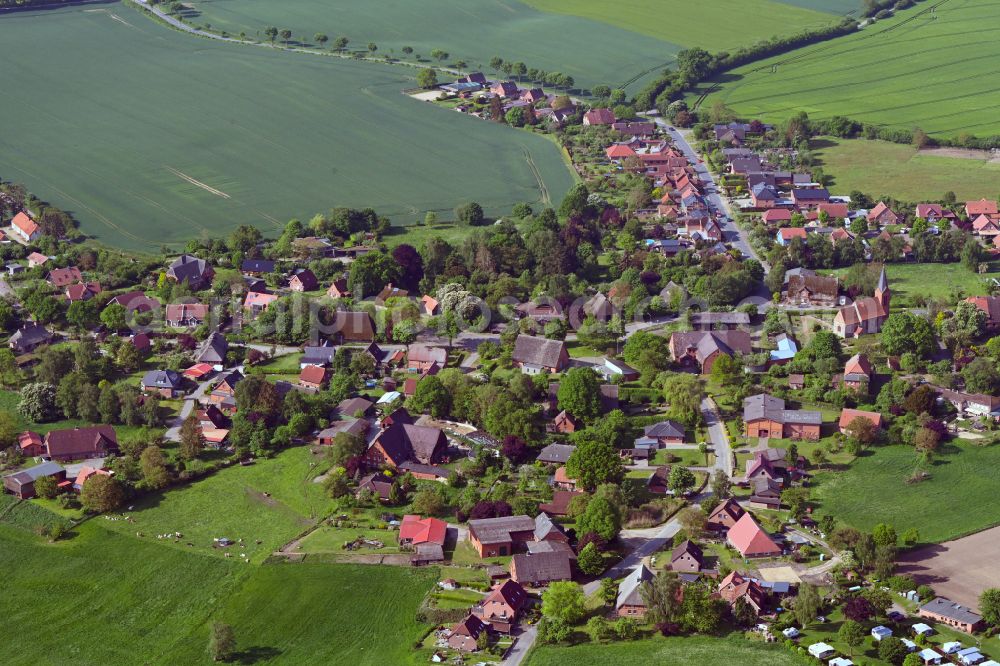 Behlendorf from above - Agricultural land and field boundaries surround the settlement area of the village in Behlendorf in the state Schleswig-Holstein, Germany