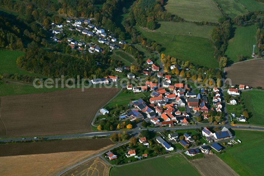 Beiershausen from above - Agricultural land and field boundaries surround the settlement area of the village in Beiershausen in the state Hesse, Germany