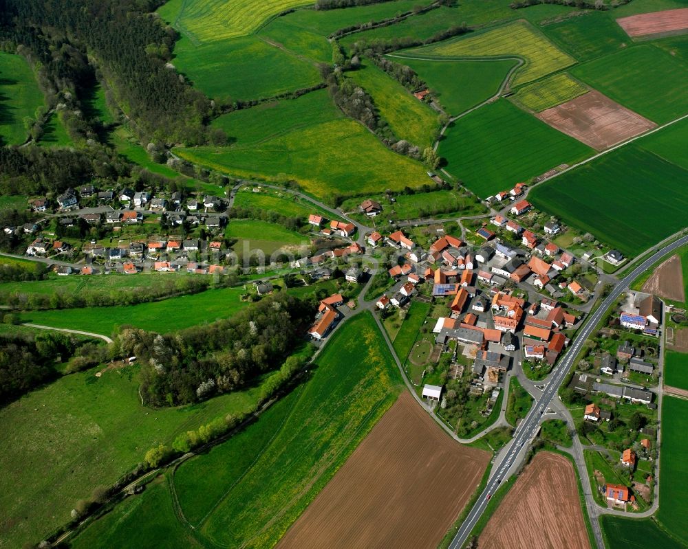 Beiershausen from above - Agricultural land and field boundaries surround the settlement area of the village in Beiershausen in the state Hesse, Germany